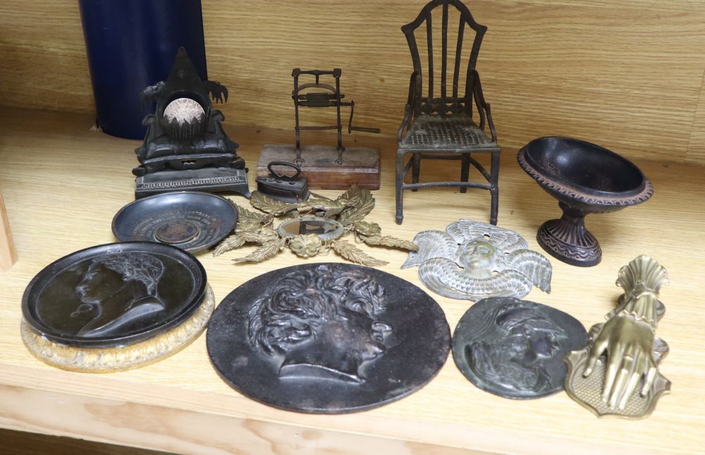 A group of 19th century iron and bronze ornaments, plaques, watch holder and urn